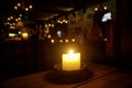 Candle on a table in a medieval tavern.