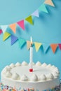 Candle on tasty birthday cake on blue background