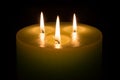 Candle with three flames on black background Royalty Free Stock Photo