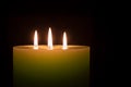 Candle with three flames on black background Royalty Free Stock Photo