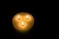 Candle with three flames on black background Royalty Free Stock Photo