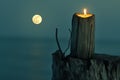 Candle on a Tree Stump with Full Moon in Background at Night Royalty Free Stock Photo