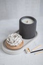 Candle, in a unique candle holder concrete blck colo rand oval coaster made from concrete in white colors. Matches for Royalty Free Stock Photo