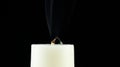 A candle whose fire goes out and leaves ashes