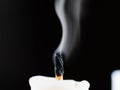 A candle wick emits smoke after being put out Royalty Free Stock Photo