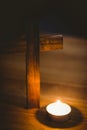 Candle by wooden cross on table Royalty Free Stock Photo