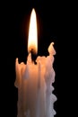 Candleflame on a lit white candle with black background Royalty Free Stock Photo