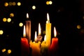 Candlelight Day. Traditional Colombian holiday. Group of candles lit at night with unfocused lights in the background Royalty Free Stock Photo