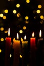 Candlelight Day. Traditional Colombian holiday. Group of candles lit at night with unfocused lights in the background Royalty Free Stock Photo