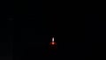 Candlelight lighting in red candle in the darkness