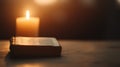 Candlelit Bible, an open scripture resting on a wooden table, warm light flickering softly, creating a serene and reflective Royalty Free Stock Photo