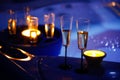 Candlelit champagne glasses beside a jacuzzi