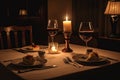 candlelit dinner for two, with wine glasses and plates set upon the table Royalty Free Stock Photo