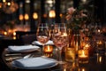 Candlelit restaurant table set with gleaming glasses and pristine dinnerware