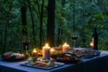 candlelit table with food platters and wine at a forest retreat Royalty Free Stock Photo