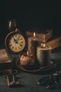 Candles,  antique books, old clock and old rusty keys in vintage style Royalty Free Stock Photo