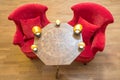 Candles on a antique side table with intarsia and red chair