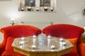 Candles on a antique side table with intarsia and red chair