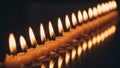 The candles, arranged closely in sequence, emit a warm and consiste Royalty Free Stock Photo