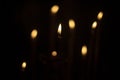Candles burn in dark. Candle lights. Flames on black background Royalty Free Stock Photo
