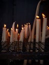 Candles burning in a candle shrine glowing in the dark Royalty Free Stock Photo