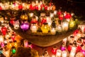 Candles burning at cemetery during All Saints` Day at night Royalty Free Stock Photo