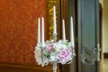 Candles burning in a chandelier on elegant dinner table Royalty Free Stock Photo