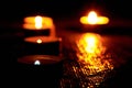 Candles burning in the dark with soft selective focus and bokeh. The concept of grief, mourning.