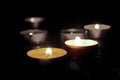 Candles burning in the dark with a soft selective focus.The concept of grief, mourning.The concept of grief, mourning.