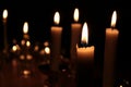 Candles burning in darkness