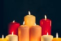 Candles burning in darkness over black background. commemoration concept. Royalty Free Stock Photo