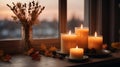 Candles burning on a windowsill with fall decor. Royalty Free Stock Photo