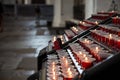 Candles in the Church. Votive prayer candles inside a catholic church on a candle rack Royalty Free Stock Photo