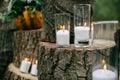 Candles in decorated goblets. Wedding decorations in rustic style. Outing ceremony. Wedding in nature.