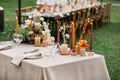 Candles, dried flowers and accessories, bouquets and glasses on table with linen tablecloth on newlywed table Royalty Free Stock Photo