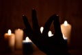 Candles and fingers mudra. Symbol of meditation folded fingers. The figure of the fingers of the mantra