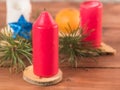 Candles, fir branches and mandarins on a wooden background