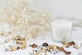 Candles with floral decor on a white table. Cozy and hygge background