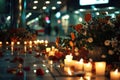 Candles and flowers on city street at night. Romantic urban decoration with natural elements