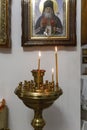 Candles in front of an icon in a Christian church. Religion and Faith. Vertkial. Selective focus Royalty Free Stock Photo