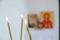 Candles in front of icons in the Orthodox church. A burning wax candles, cross and icons in monastery. Christian religion. Altar i Royalty Free Stock Photo