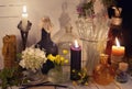 Candles, glass bottles, jars and flowers on the table Royalty Free Stock Photo