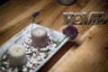 Candles with home sign on wooden table- rest and relaxation