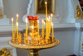 Candles at the icon in the Orthodox church. Religious holiday, great fasting, prayer concept