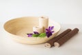 Candles and iris flowers in wooden bowel and mat Royalty Free Stock Photo