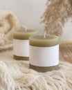 Candles with label on cosy cream sweater near dry pampas grass, Close up, mock up