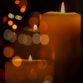 Candles lit in a black background. Isolated