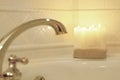 Candles lit in a blurred romantic bath.