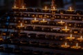 Rows of candles in a holder in a Cathedral, with selective focus Royalty Free Stock Photo