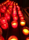 votive red candles lit during the religious rite inside the place of worship Royalty Free Stock Photo